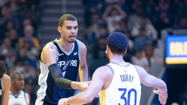 San Antonio Spurs center Victor Wembanyama (1) shakes hands with Golden State Warriors guard Stephen Curry (30) before the game at Chase Center.